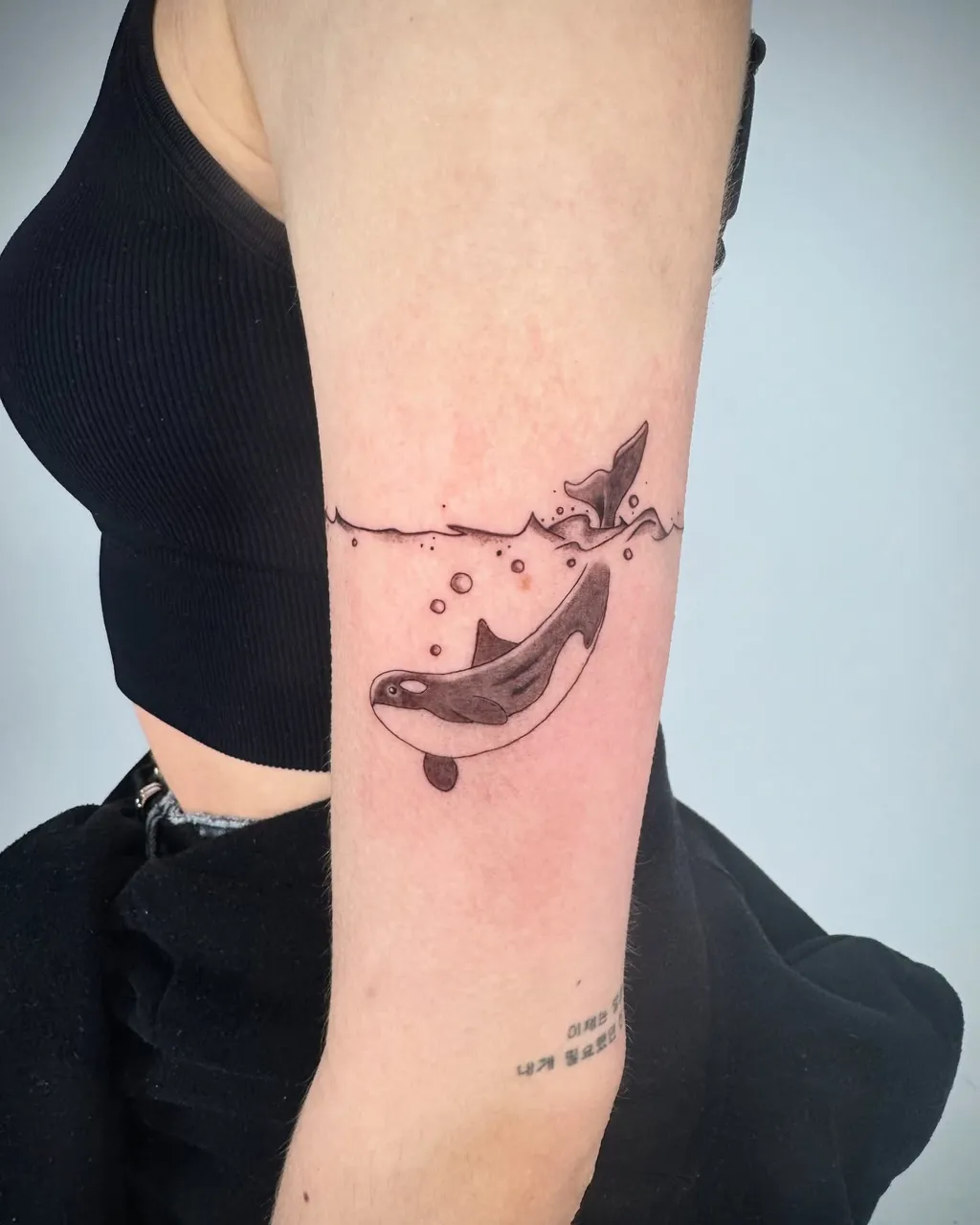 Playful Orca Upper Arm Tattoos for Women