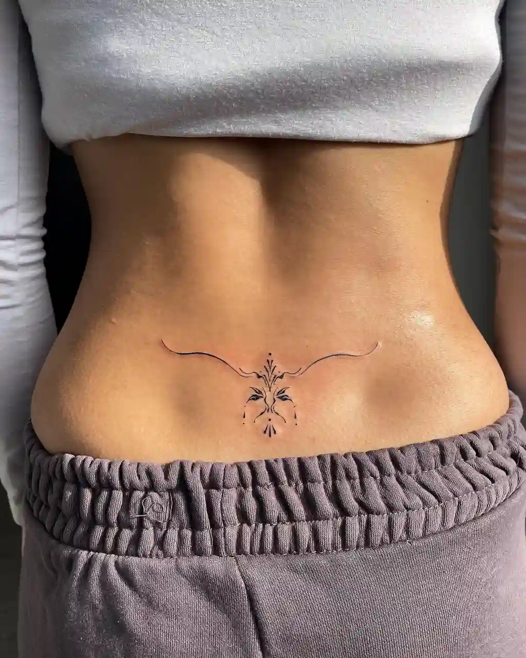 Minimal Elegant Curve Lower Back Tattoos for Women