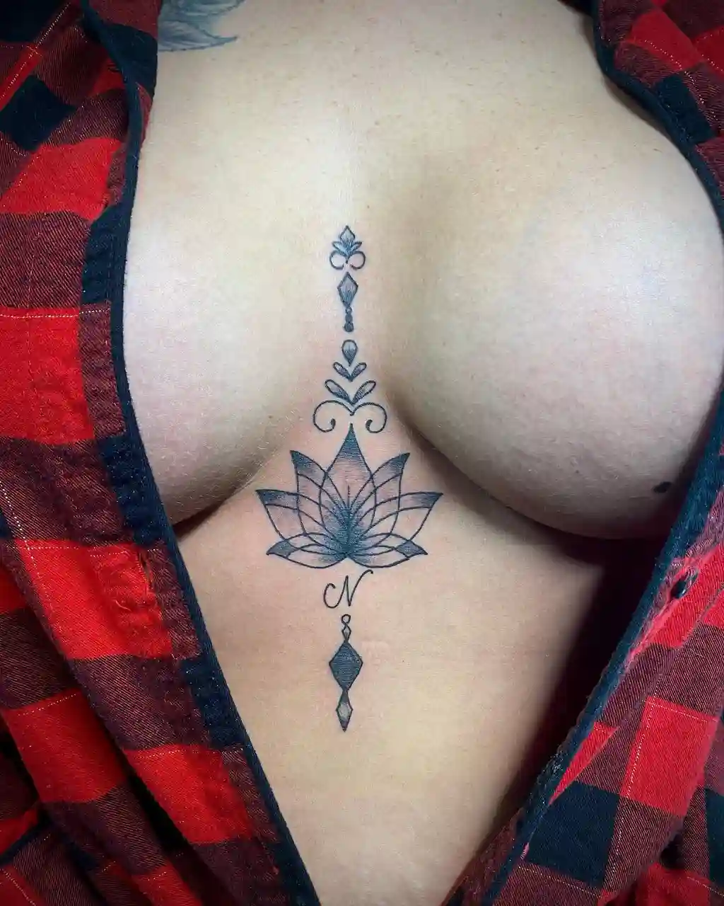 Chest Tattoo Female with Lotus and Initial Design