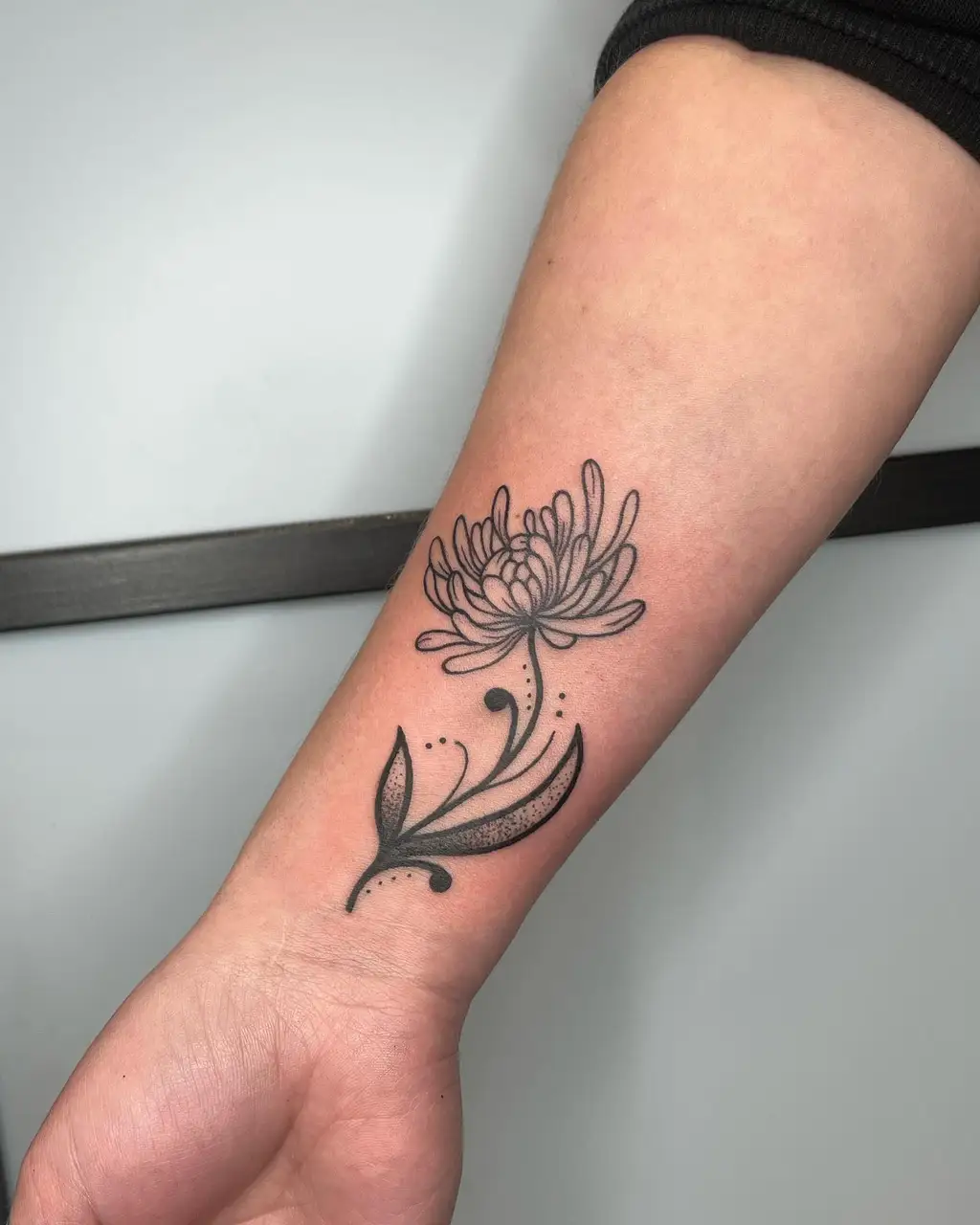 Wrist Tattoo with Blooming Chrysanthemum Design