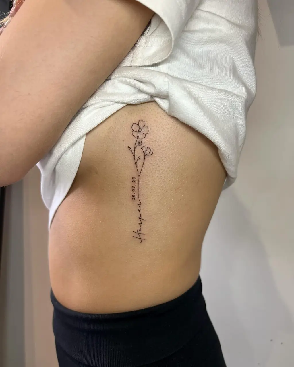Delicate Name & Flower Rib Tattoos for Women