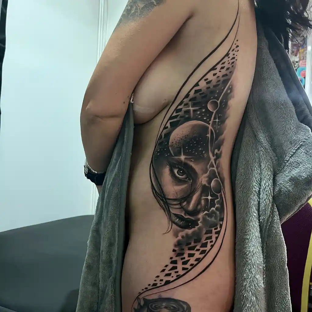 Cosmic Portrait Rib Tattoos for Women
