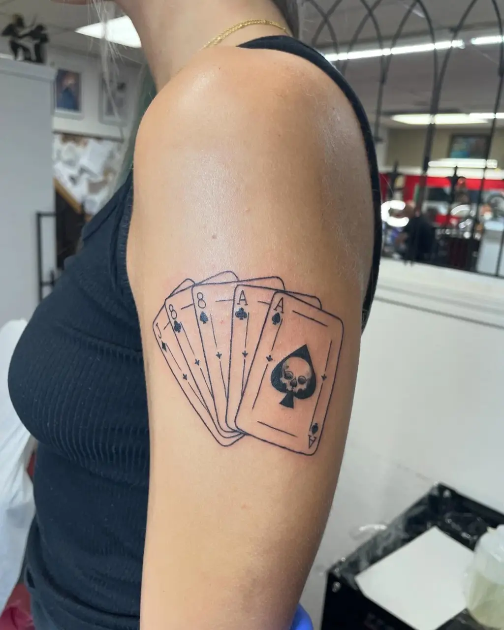 Dead Man’s Hand Upper Arm Tattoos for Women