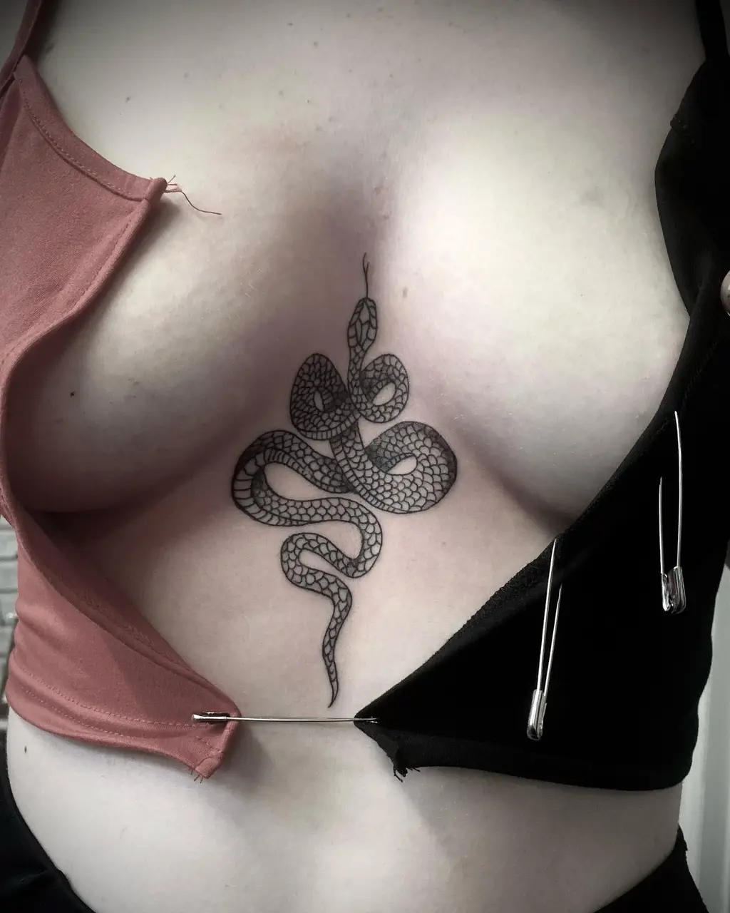 Chest Tattoo Female with Coiled Snake Symbol