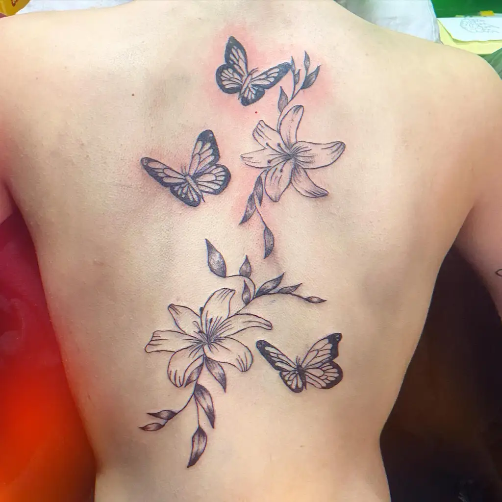 Butterfly and Lily Back Tattoo Inspiration for Women