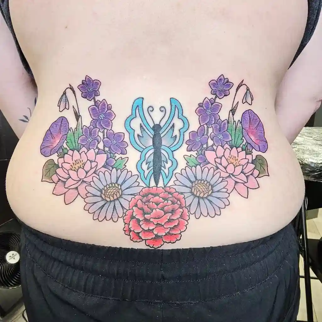 Colorful Butterfly and Floral Lower Back Tattoo