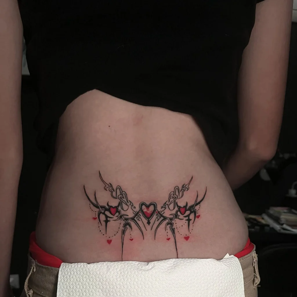 Heart-Centered Tribal Lower Back Tattoo