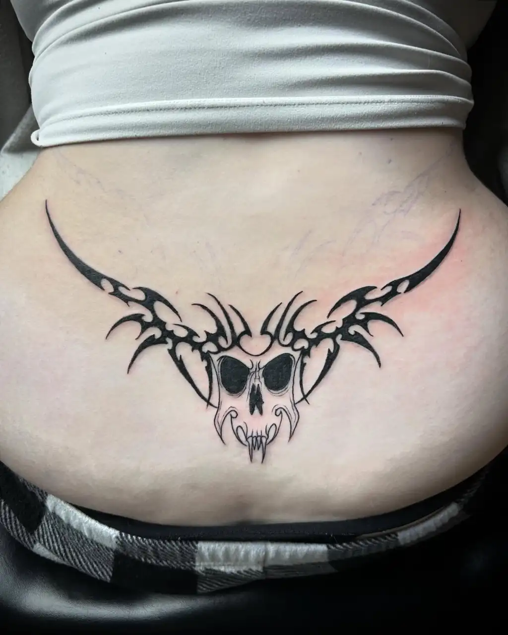 Skull Tribal Lower Back Tattoo