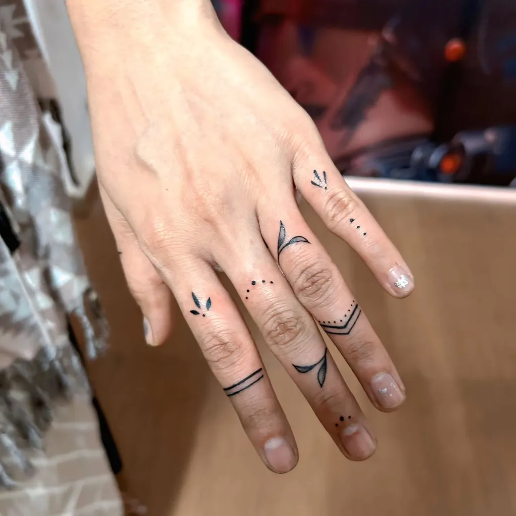 Finger Tattoos for Women with Tribal-Inspired Dot and Leaf Patterns