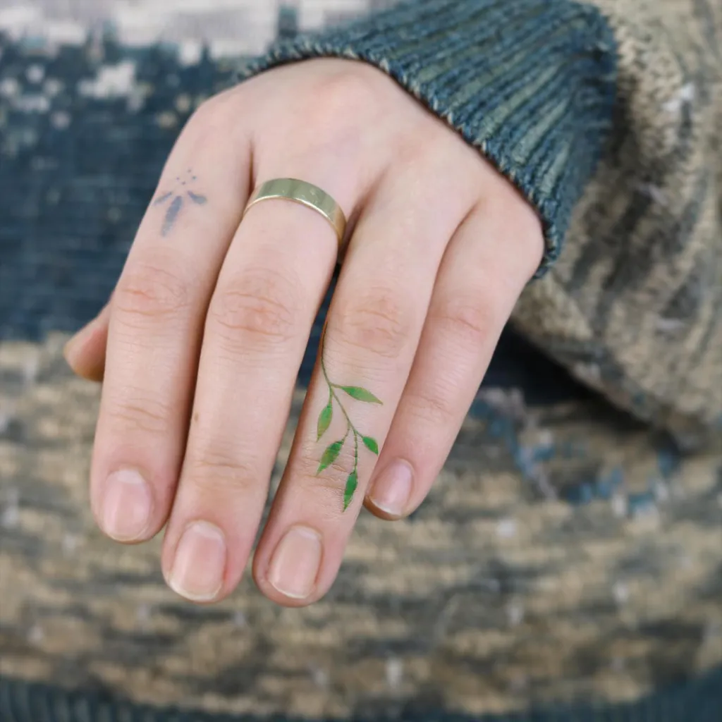 Finger Tattoos for Women with Delicate Green Leaf Vine